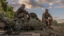 Ukrainian tank crew take a break while operating a Soviet-made T-72 tank in the Sumy region, near the border with Russia, on August 12, 2024, amid the Russian invasion of Ukraine. Ukraine launched a surprise offensive into the Russian border region of Kursk on August 6, 2024, capturing over two dozen towns and villages in the most significant cross-border attack on Russian soil since World War II. Ukraine's military chief Oleksandr Syrsky told President Volodymyr Zelensky in a video posted on August 12, 2024 that his troops now control about 1,000 square kilometres of Russian territory and are continuing "offensive operations". (Photo by Roman PILIPEY / AFP) (Photo by ROMAN PILIPEY/AFP via Getty Images)