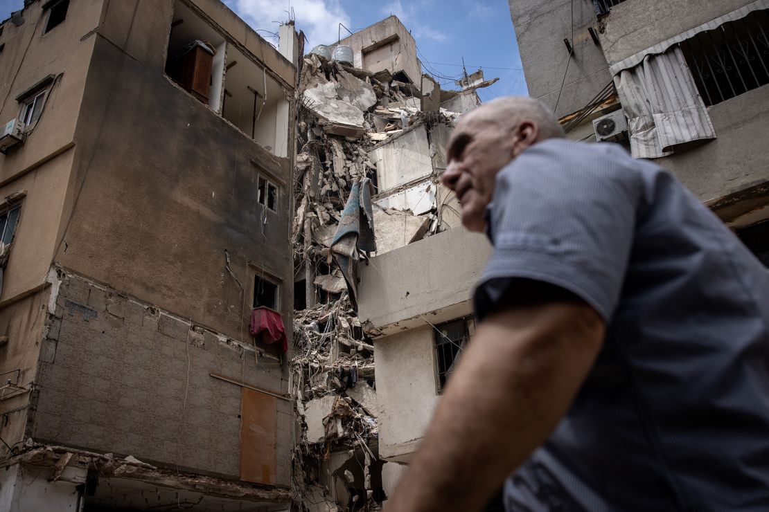 A man walks past a building destroyed by the Israeli strike that killed Shukr in Daniyeh suburb, Beirut, August 9, 2024.