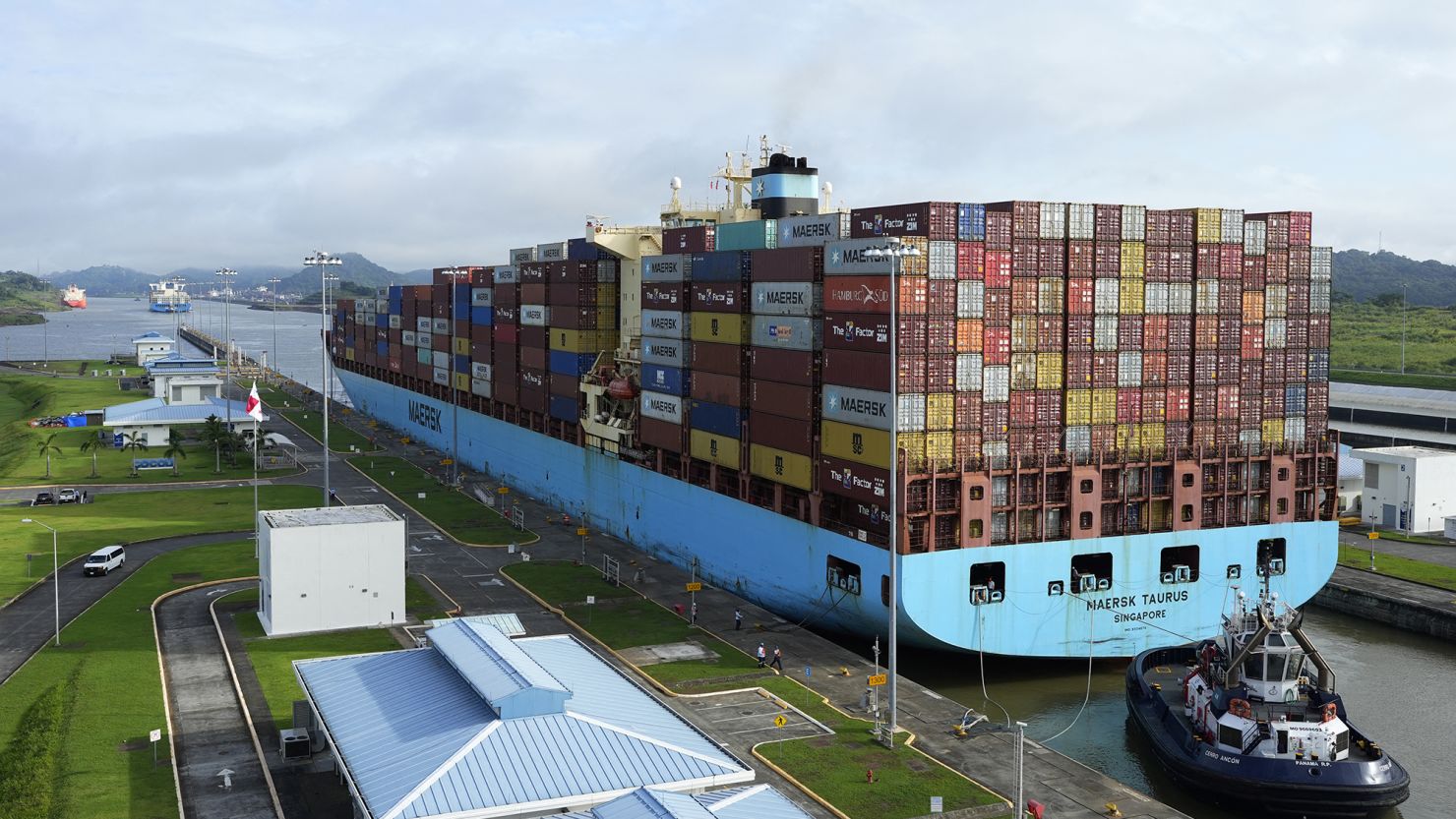 A cargo ship and tugboat sail through the Cocoli Locks at the Panama Canal on August 12.