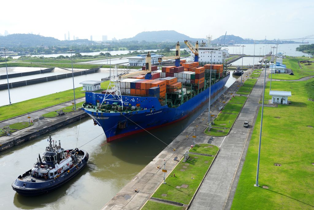 A cargo ship and tugboat sail through the Cocoli Locks at the Panama Canal, in Panama, on August 12, 2024.