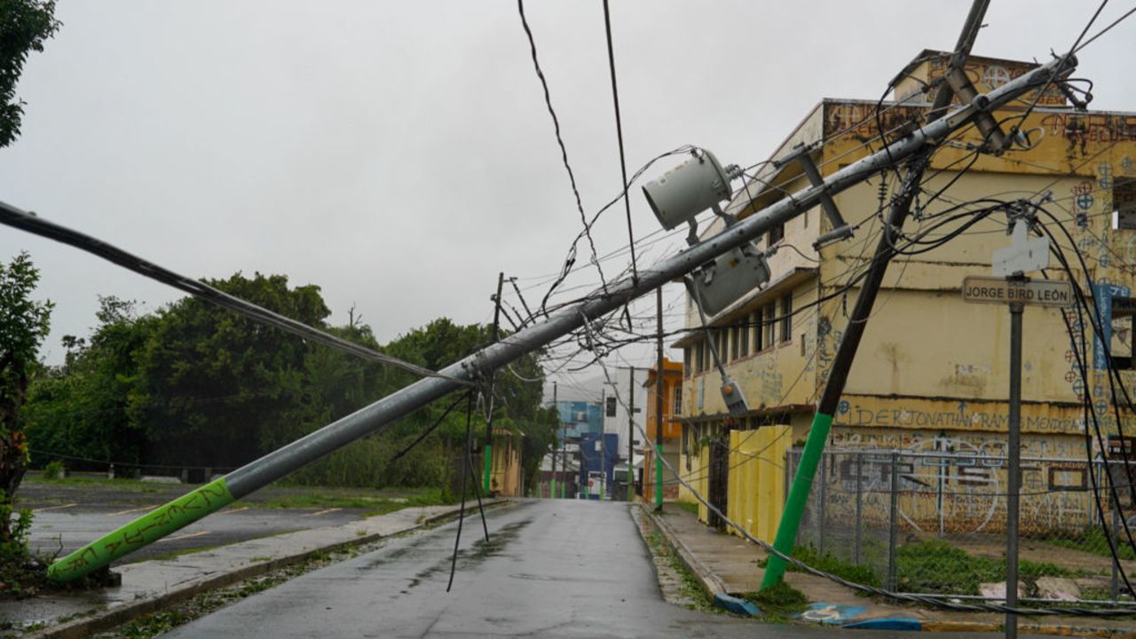 TOPSHOT - Broken electricity lines above homes damaged are seen after Tropical Storm Ernesto hit Fajardo, Puerto Rico, on August 14, 2024. On August 13, Ernesto advanced through the Caribbean toward Puerto Rico, where officials shut down schools and sent workers home as forecasters warned of a possible hurricane.
The storm was moving west toward the US island with maximum sustained winds of 50 miles per hour (85kph), according to the National Hurricane Center. (Photo by Jaydee Lee SERRANO / AFP) (Photo by JAYDEE LEE SERRANO/AFP via Getty Images)