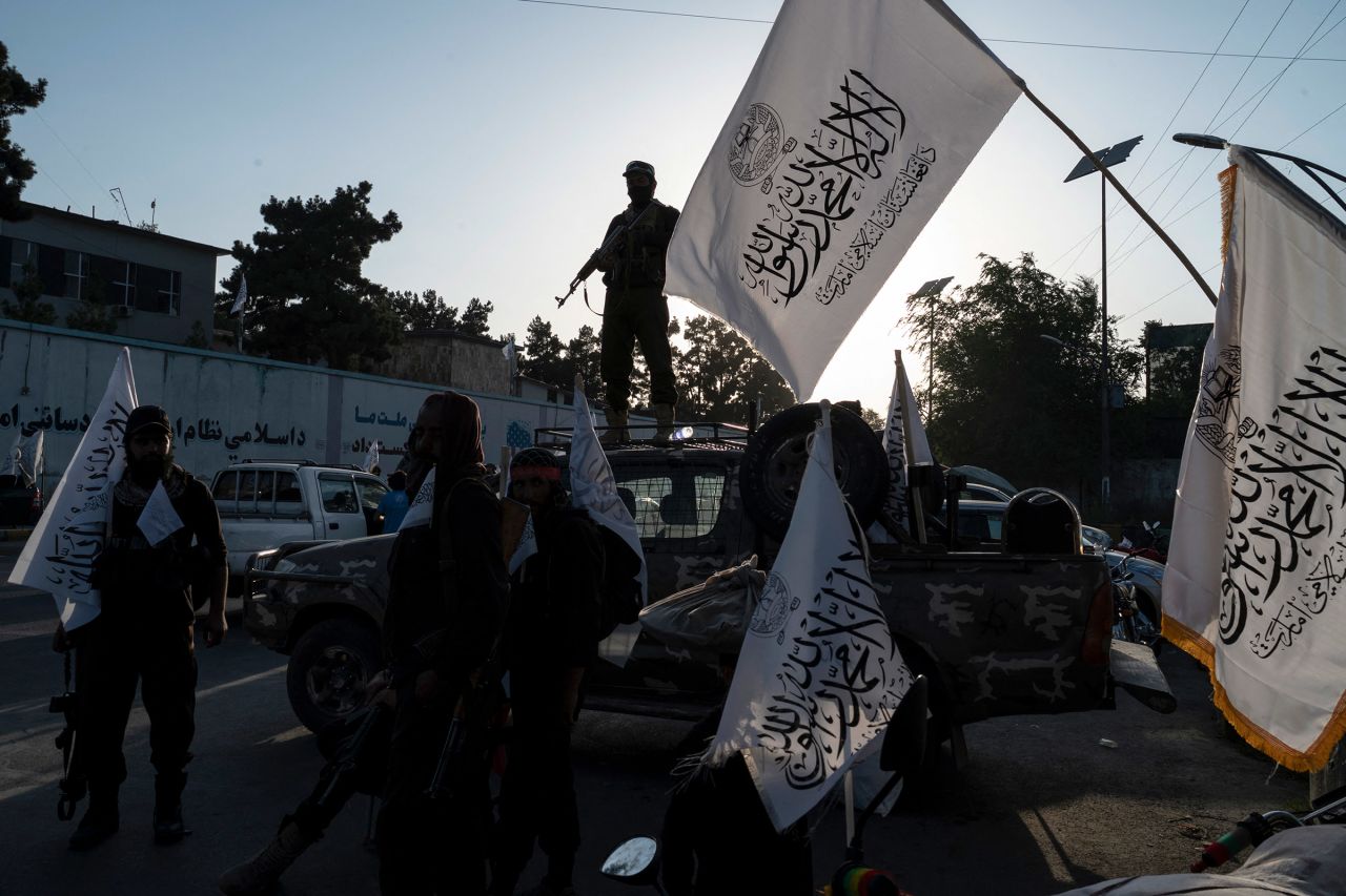 Taliban security personnel ride on a vehicle as they celebrate the third anniversary of Taliban takeover of Afghanistan, in Kabul, Afghanistan on August 14.