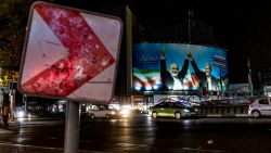 A banner depicts the late Hamas leader Ismail Haniyeh (left) joining hands with Iranian President Masoud Pezeshkian in a square in downtown Tehran, Iran, on Aug. 12, 2024. The Biden administration has urged Iran to rethink its reaction to the blast that killed Haniyeh. (Photo by Saman / Middle East Images / Middle East Images via AFP) (Photo by SAMAN/Middle East Images/AFP via Getty Images)