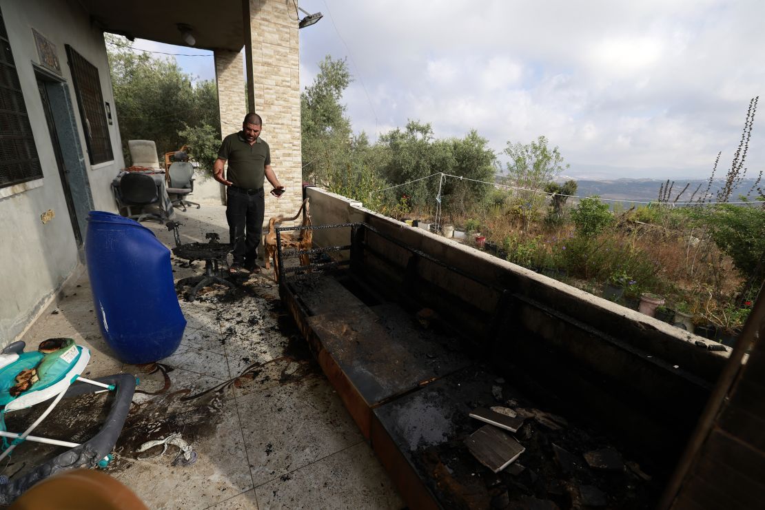 A man checks the damage in his house, a day after an attack by Jewish settlers on the village of Jit near Nablus in the occupied West Bank that left a 23-year-old man dead and others with critical gunshot wounds, on August 16, 2024. Negotiators trying to hash out a Gaza ceasefire deal were due to meet for a second day in Qatar on August 16, after the deadly Jewish settler attack on the Palestinian village drew widespread rebuke, including from Israeli officials. (Photo by Jaafar ASHTIYEH / AFP) (Photo by JAAFAR ASHTIYEH/AFP via Getty Images)