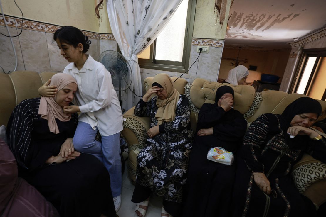 TOPSHOT - A young girl comforts the mother of a 23-year-old Palestinian man, a day after he was killed during an attack by Jewish settlers on the village of Jit near Nablus in the occupied West Bank, on August 16, 2024. Negotiators trying to hash out a Gaza ceasefire deal were due to meet for a second day in Qatar on August 16, after the deadly Jewish settler attack on the Palestinian village drew widespread rebuke, including from Israeli officials. (Photo by Jaafar ASHTIYEH / AFP) (Photo by JAAFAR ASHTIYEH/AFP via Getty Images)