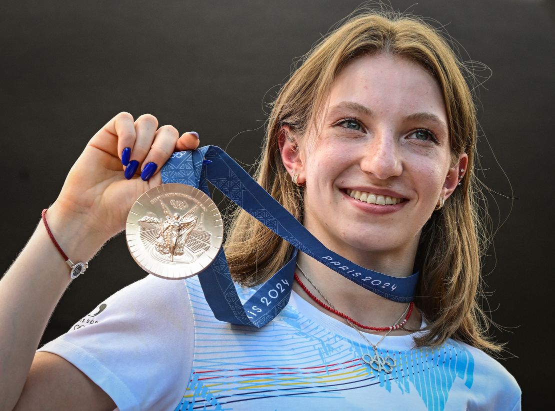 Romanian gymnast Ana Maria Barbosu poses with her Olympic bronze medal she was given on August 16, 2024 in Bucharest, Romania, after a gymnast from the US was stripped of it.