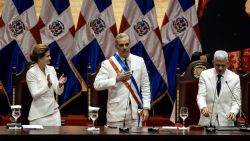 Dominican Republic President Luis Abinader (C) poses with the presidential sash next to Senate President Ricardo de los Santos (R) and Vice President Raquel Pena during the inauguration ceremony at the National Palace in Santo Domingo on August 16, 2024. Dominican President Luis Abinader was reelected for the 2024-2028 term. (Photo by Francesco SPOTORNO / AFP) (Photo by FRANCESCO SPOTORNO/AFP via Getty Images)