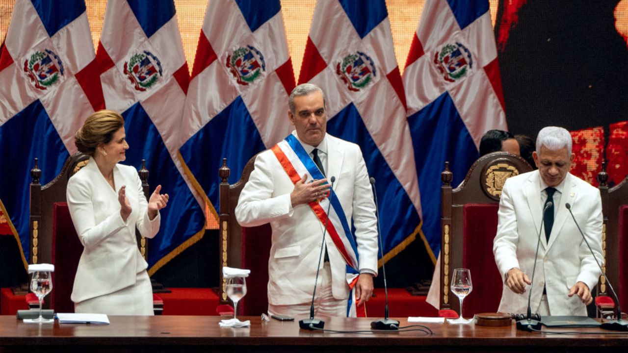 Dominican Republic President Luis Abinader (C) poses with the presidential sash next to Senate President Ricardo de los Santos (R) and Vice President Raquel Pena during the inauguration ceremony at the National Palace in Santo Domingo on August 16, 2024. Dominican President Luis Abinader was reelected for the 2024-2028 term. (Photo by Francesco SPOTORNO / AFP) (Photo by FRANCESCO SPOTORNO/AFP via Getty Images)