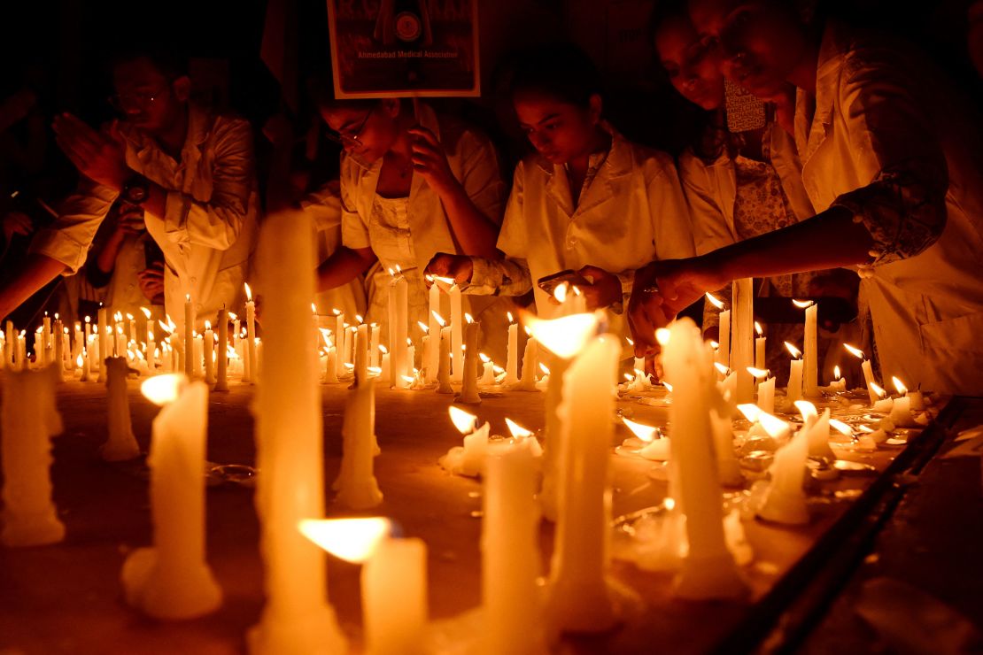 Medical professionals light candles during a demonstration in Ahmedabad, India, held on August 17, 2024, amid a nationwide strike by doctors to condemn the rape and murder of a young medic from Kolkata.