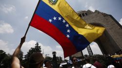 A man waves a Venezuelan flag during a protest called by the Venezuelan opposition for election 'victory' to be recognised at Monumento a la Revolucion in Mexico City on August 17, 2024. Venezuelan opposition leader Maria Corina Machado had called for mass gatherings in more than 300 cities in Venezuela and abroad to intensify pressure on Maduro to concede what she says was an overwhelming opposition win in the July 28 presidential polls. (Photo by Rodrigo Oropeza / AFP) (Photo by RODRIGO OROPEZA/AFP via Getty Images)