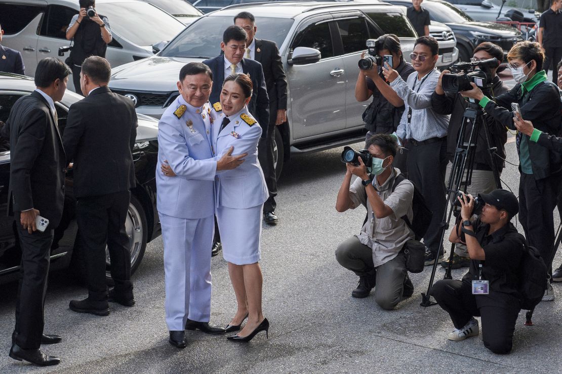 Paetongtarn Shinawatra hugs her father Thaksin Shinawatra as they arrive for the royal confirmation ceremony in Bangkok, Thailand on August 18, 2024.