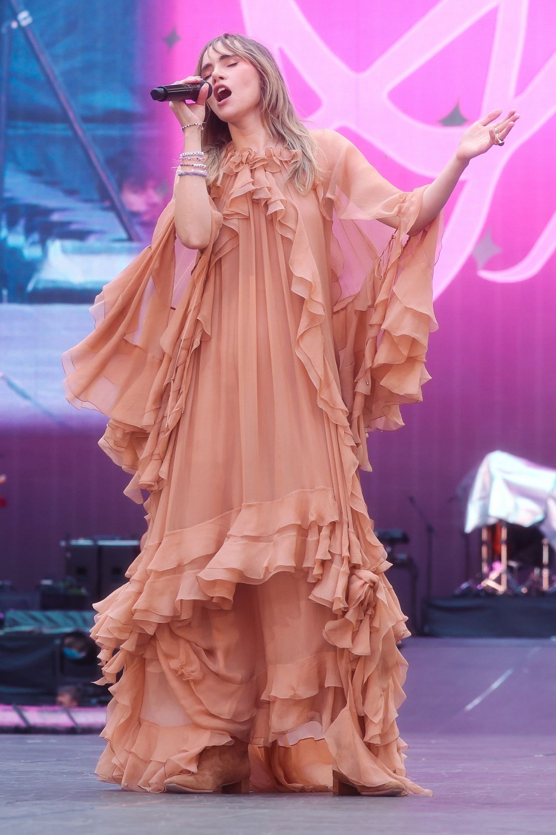 Suki Waterhouse performed in a reddish dress by Chloé as the opening act for Swift at Wembley Stadium on August 17.