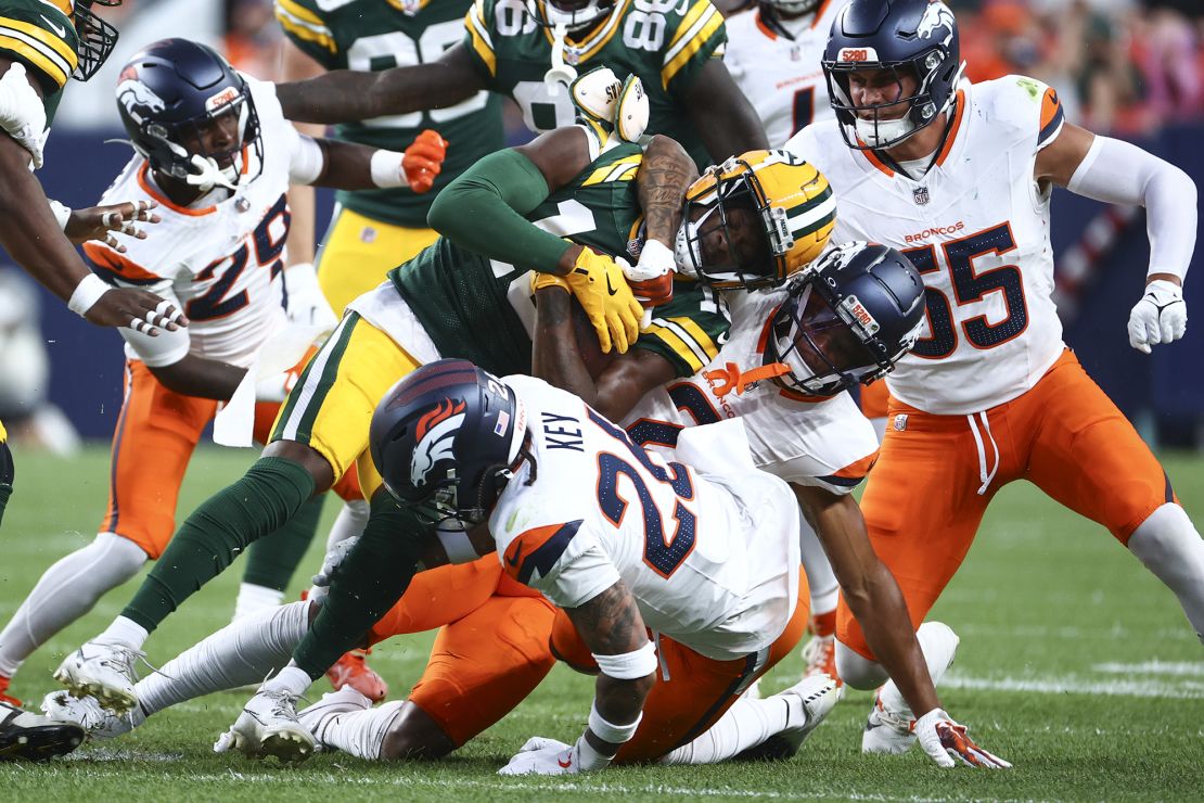 Denver's Pat Surtain II tackles the Packers wide receiver Malik Heath.