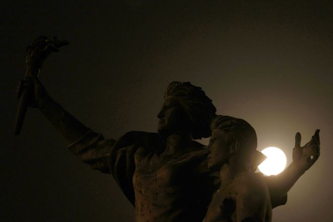 The super blue moon is seen behind the Martyrs' Monument in Beirut, Lebanon.