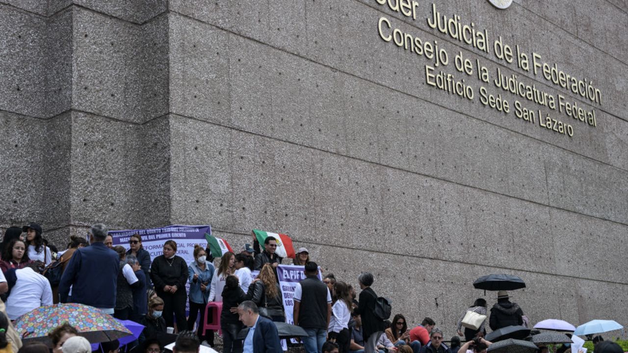 Judiciary workers on an indefinite strike remain in front of the Federal Judicial Branch building in Mexico City on August 19, 2024. Hundreds of Mexican judiciary workers began a strike on Monday in protest against a controversial constitutional reform in which the left-wing government seeks to have judges and magistrates elected by popular vote. (Photo by Yuri CORTEZ / AFP) (Photo by YURI CORTEZ/AFP via Getty Images)