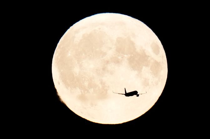 An aircraft flies in front of the super blue moon over Copenhagen, Denmark, on Monday.