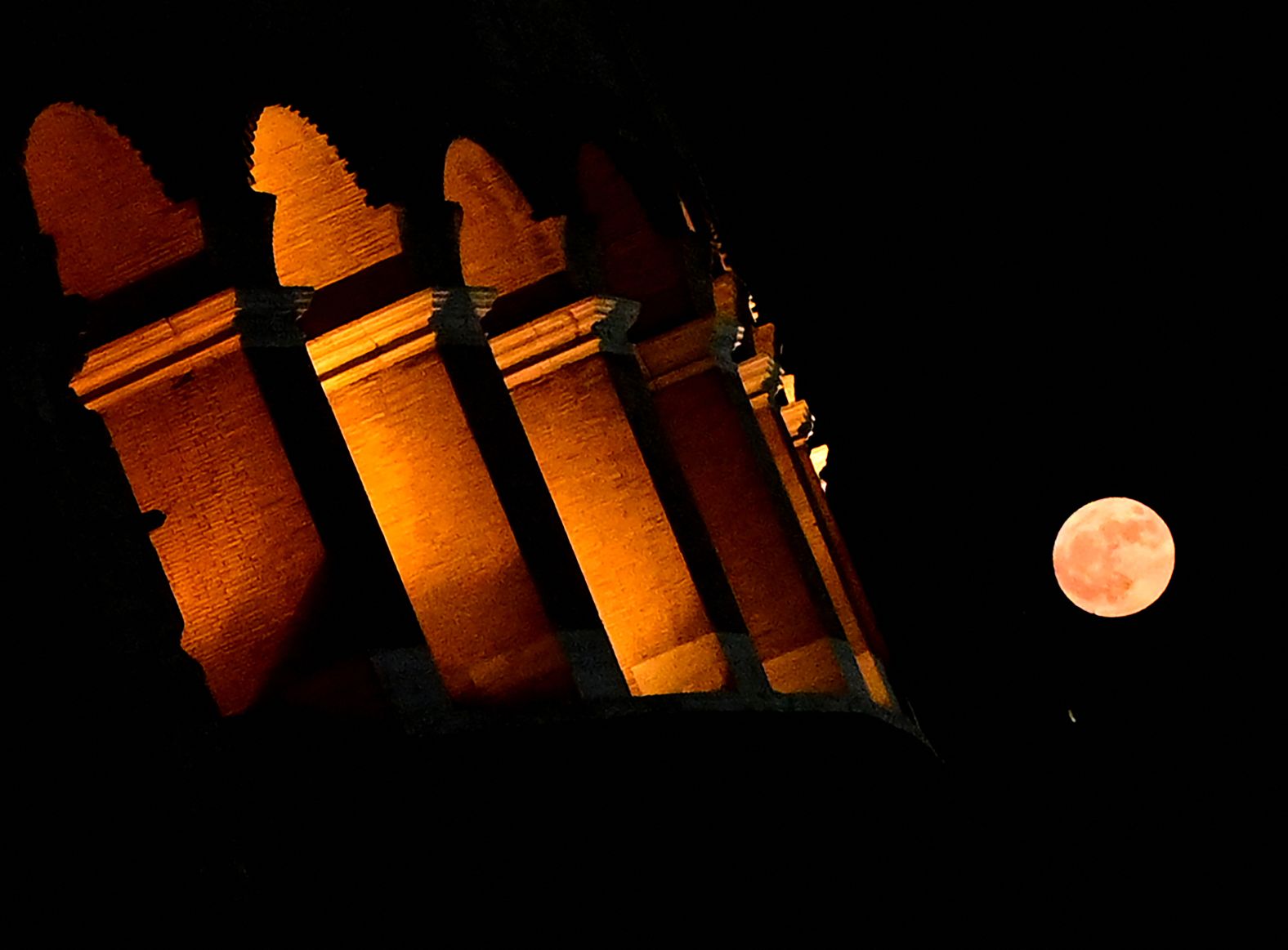 The super moon rises near Rome's Colosseum on Monday.