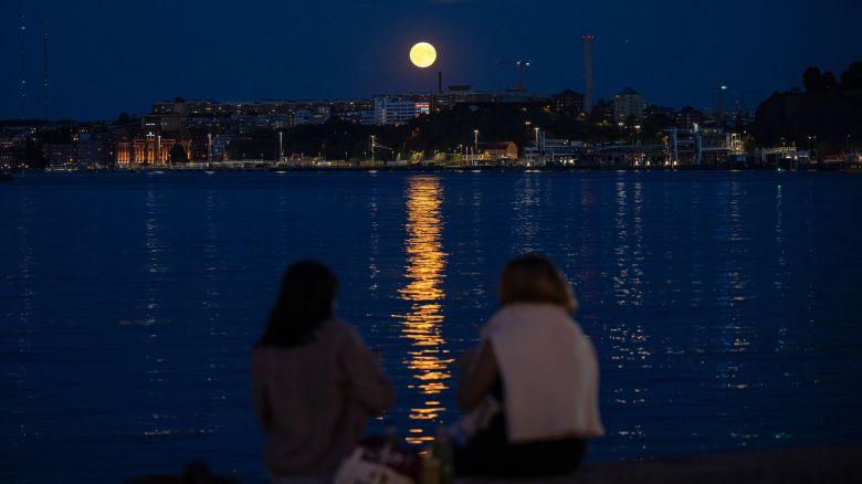 People in Stockholm, Sweden, watch the super blue moon rise behind Nacka on Monday, August 19.