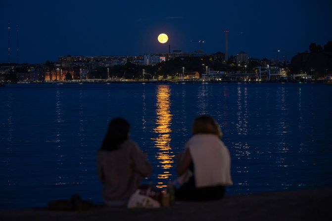 People in Stockholm, Sweden, watch the super blue moon rise behind Nacka on Monday, August 19.