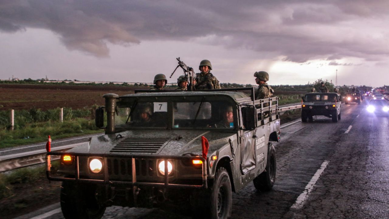 TOPSHOT - Mexican army soldiers aboard military vehicles patrol a highway as part of a military operation to reinforce security following a wave of violence in recent days in the city of Culiacan, Sinaloa State, Mexico, on August 19, 2024. (Photo by Ivan MEDINA / AFP) (Photo by IVAN MEDINA/AFP via Getty Images)