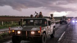 TOPSHOT - Mexican army soldiers aboard military vehicles patrol a highway as part of a military operation to reinforce security following a wave of violence in recent days in the city of Culiacan, Sinaloa State, Mexico, on August 19, 2024. (Photo by Ivan MEDINA / AFP) (Photo by IVAN MEDINA/AFP via Getty Images)