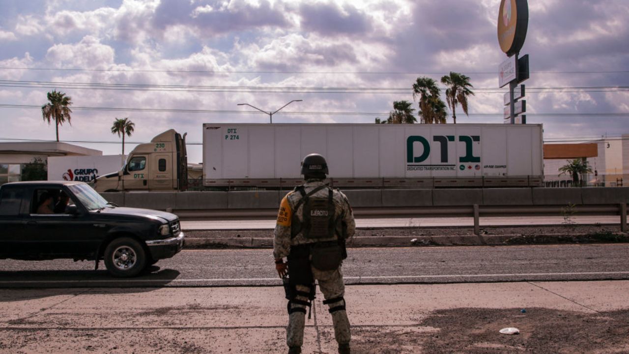 TOPSHOT - A Mexican army soldier stands guard in a highway as part of a military operation to reinforce security following a wave of violence in recent days in the city of Culiacan, Sinaloa State, Mexico, on August 19, 2024. (Photo by Ivan MEDINA / AFP) (Photo by IVAN MEDINA/AFP via Getty Images)