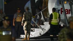 A Colombian migrant, with his hands and feet handcuffed, climbs a plane at the Albrook Gelabert airport in Panama City on August 20, 2024, during his deportation. Panama on Tuesday deported 29 Colombians with criminal records who had entered the country through the inhospitable Darien Gap, applying for the first time a deal on migrant repatriations signed with the United States in July. (Photo by ARNULFO FRANCO / AFP)