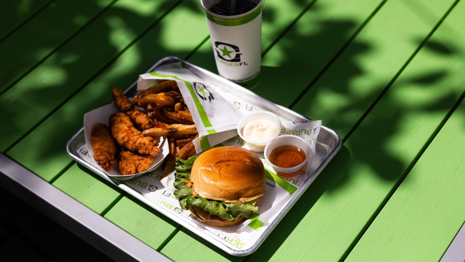 In this photo illustration, a burger, fries, and chicken tenders from BurgerFi are displayed on August 20, 2024 in Arlington, Virginia.
