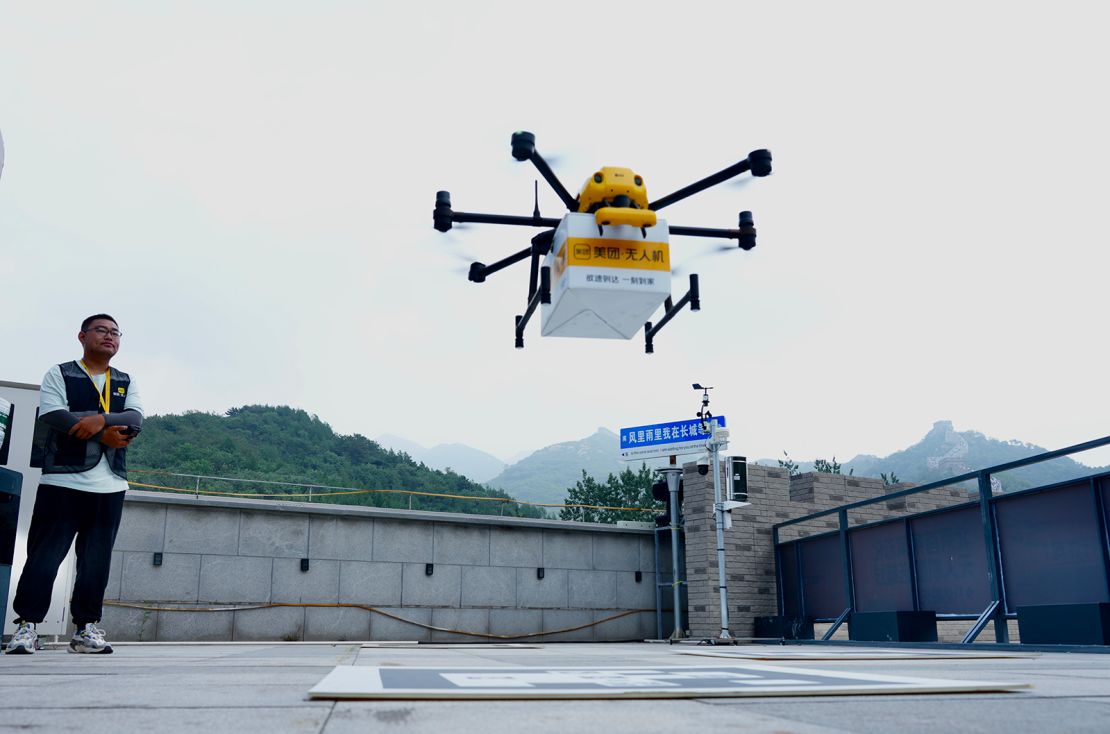 The drones are launched by an operator from the rooftop of a hotel near the Badaling section of the Great Wall in Beijing, China.