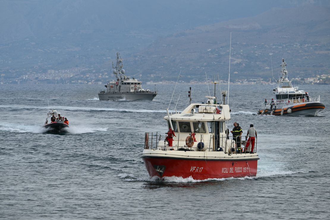 Rescue boats return to Porticello harbor near Palermo, after they found two bodies, on August 21, 2024, two days after the luxury yacht Bayesian sank.