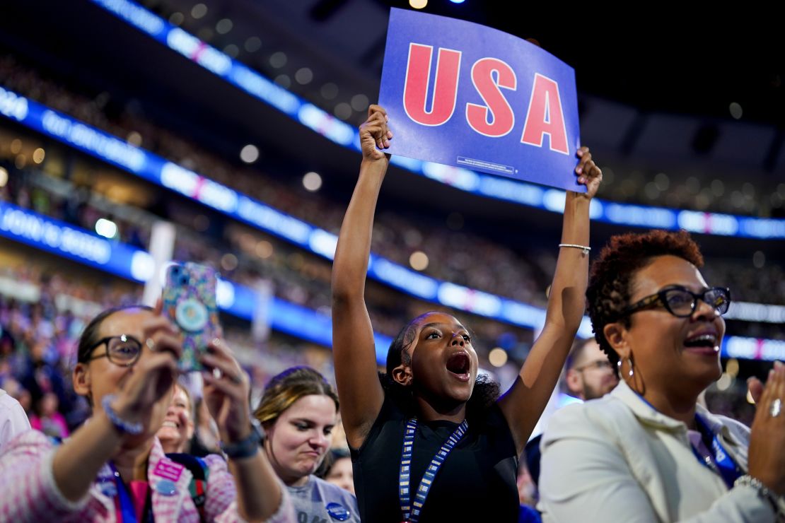 A delegate holds a "USA" sign during the Democratic National Convention (DNC) at the United Center in Chicago, Illinois, US, on Wednesday, Aug. 21, 2024. The Democratic National Convention this week marks the ceremonial crowning of Vice President Kamala Harris and Minnesota Governor Tim Walz as the party's presidential nominees, capping off a whirlwind month for Democrats who quickly coalesced behind the new ticket after President Joe Biden dropped out of the race in July. Photographer: Al Drago/Bloomberg via Getty Images