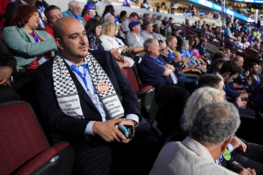 Abbas Alawieh, cofounder of the uncommitted movement, sits with fellow Michigan delegates at the DNC in Chicago, on August 19, 2024.