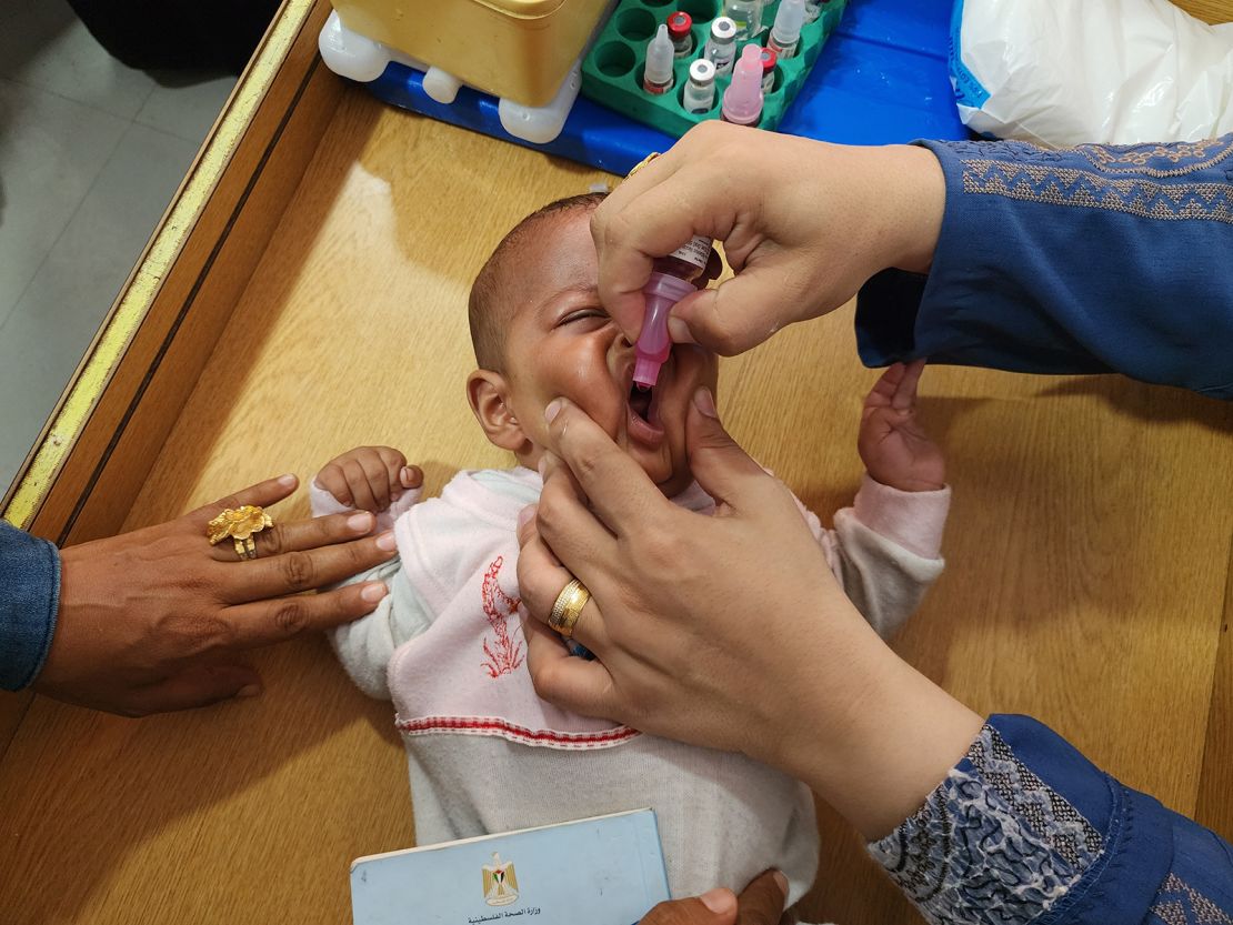 A medical team from the Palestinian Red Crescent vaccinates a child against poiio as part of a routine campaign at Al-Amal Hospital in Khan Younis on August 22.