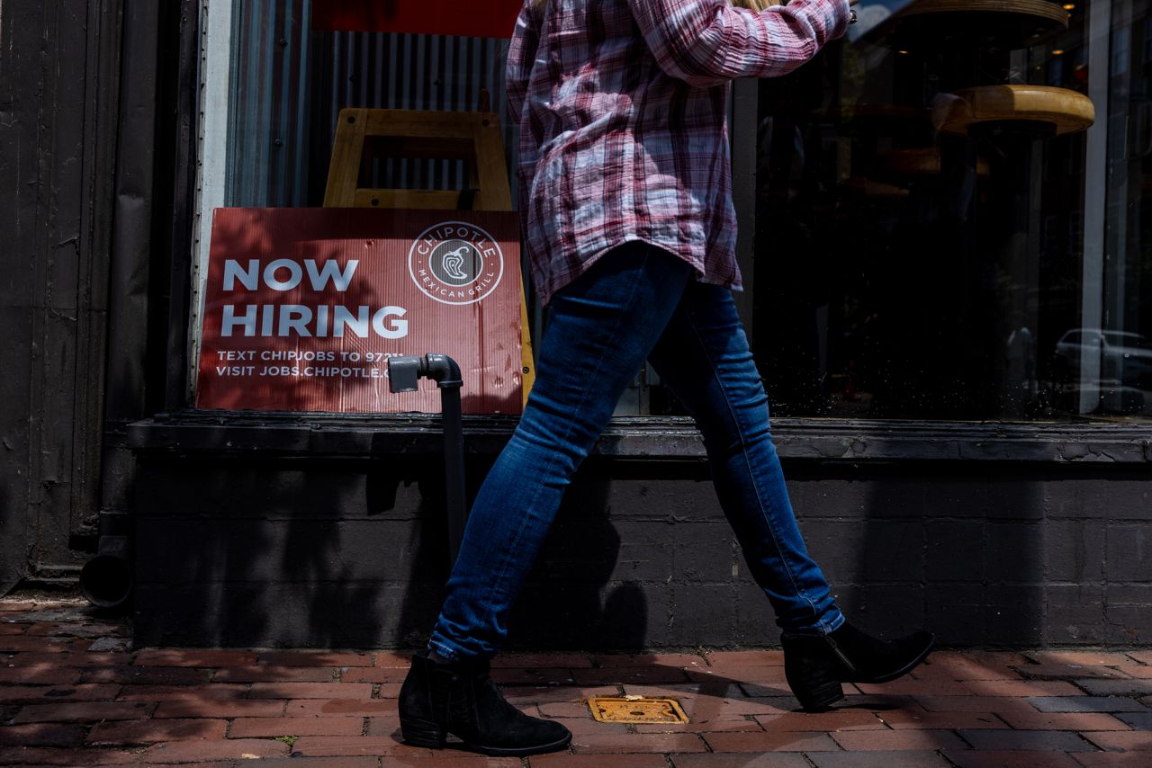 A hiring sign is displayed in the window of a Chipotle on August 22 in Alexandria, Virginia.