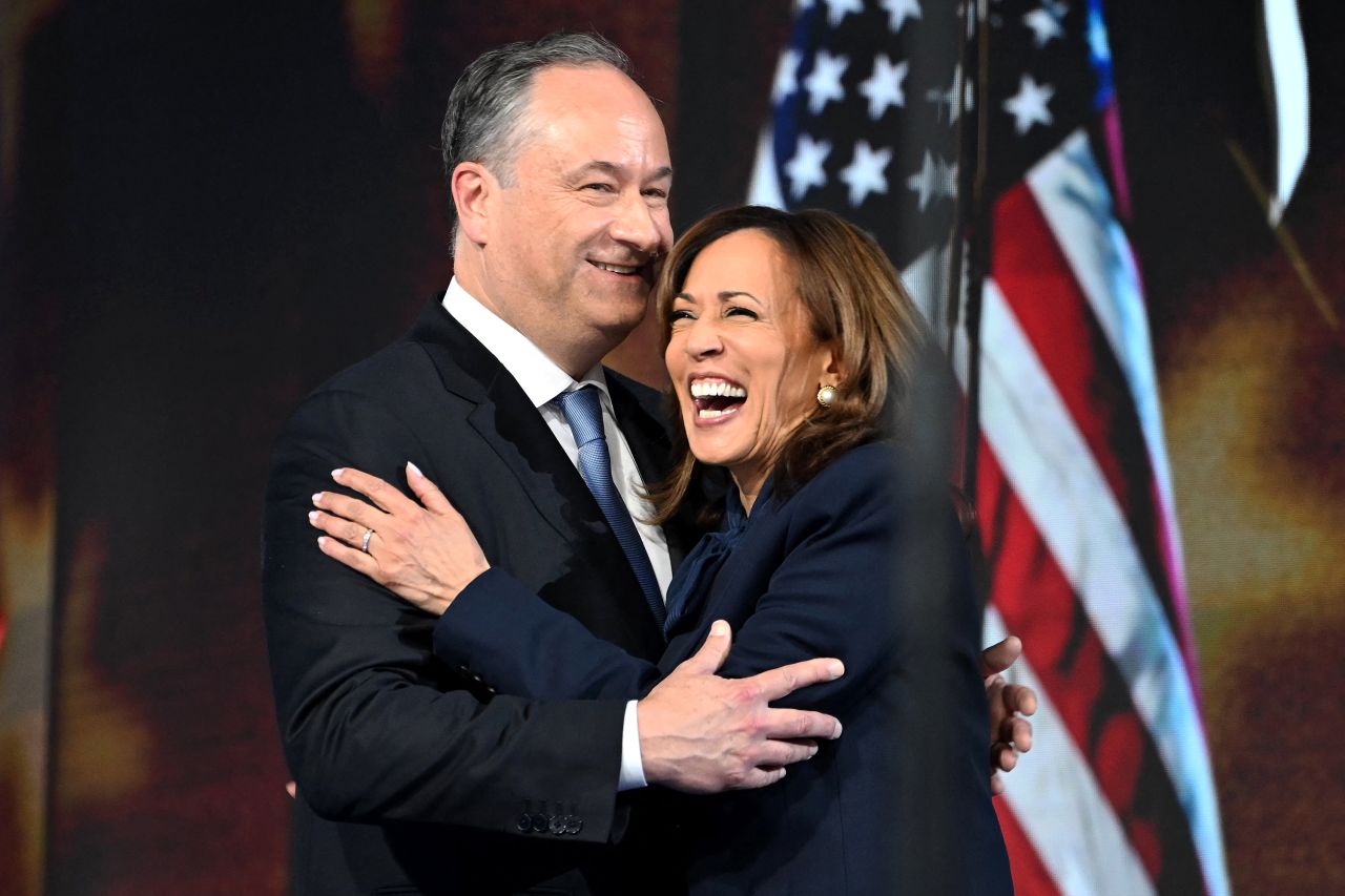 Second gentleman Doug Emhoff hugs Vice President Kamala Harris at the Democratic National Convention in Chicago on August 22.