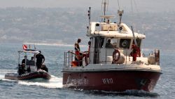 Divers of the Vigili del Fuoco, the Italian Corps. of Firefighters enter Porticello harbor near Palermo, with the body of Hannah Lynch, the last missing person at the back of the boat on August 23, 2024, four days after the British-flagged luxury yacht Bayesian sank. Divers searching a sunken superyacht off Sicily for UK tech tycoon Mike Lynch's teenage daughter found a body, a coastguard official told AFP. Lynch's daughter Hannah, 18, had been the last person missing after his family's luxury yacht sank off the Italian island killing the businessman and five others. The Bayesian, which had 22 people aboard including 10 crew, was anchored some 700 metres from port before dawn when it was struck by a waterspout.