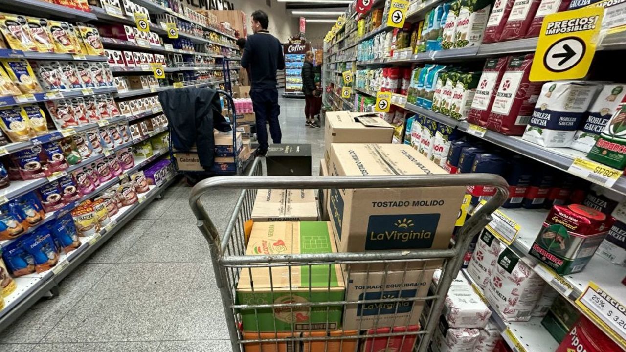 A worker replenishes merchandise at a supermarket in Buenos Aires, on August 23, 2024. (Photo by STRINGER / AFP) (Photo by STRINGER/AFP via Getty Images)