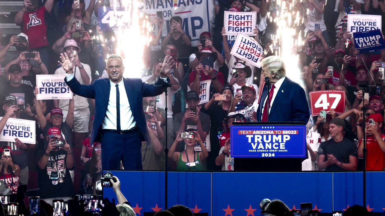 TOPSHOT - Former US President and Republican presidential candidate Donald Trump (R) welcomes onstage Independent presidential candidate Robert F. Kennedy Jr. (L)  during a campaign rally at the Desert Diamond Arena in Glendale, Arizona, August 23, 2024. Robert F. Kennedy Jr, scion of America's storied political clan, suspended his long shot presidential bid on August 23, 2024 and endorsed Donald Trump, injecting a new dose of uncertainty into the White House race. (Photo by Olivier TOURON / AFP) (Photo by OLIVIER TOURON/AFP via Getty Images)