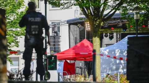 Police investigators pictured Saturday morning standing at the site of Friday's deadly stabbings in Solingen, western Germany.