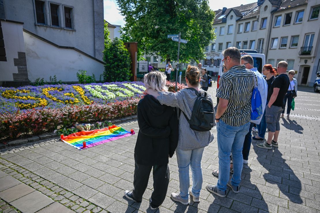 People mourn the victims of Friday's stabbing attack.