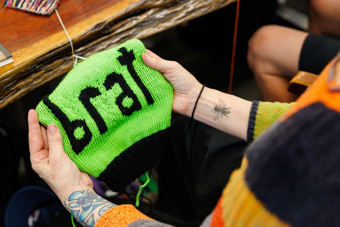 Annette Corsino, owner of the Knitting Tree LA, works on a "brat" hat in support of presidential candidate Vice President Kamala Harris in Inglewood, California, on July 31, 2024.