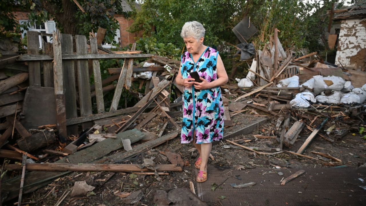 A woman walks at the site of a missile strike in Kharkiv, on August 25, 2024, amid the Russian invasion of Ukraine. (Photo by SERGEY BOBOK / AFP) (Photo by SERGEY BOBOK/AFP via Getty Images)