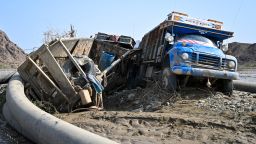 Damaged trucks buried in the mud after the collapse of the Arbaat Dam, 40km north of Port Sudan following heavy rains and torrential floods on August 25, 2024.