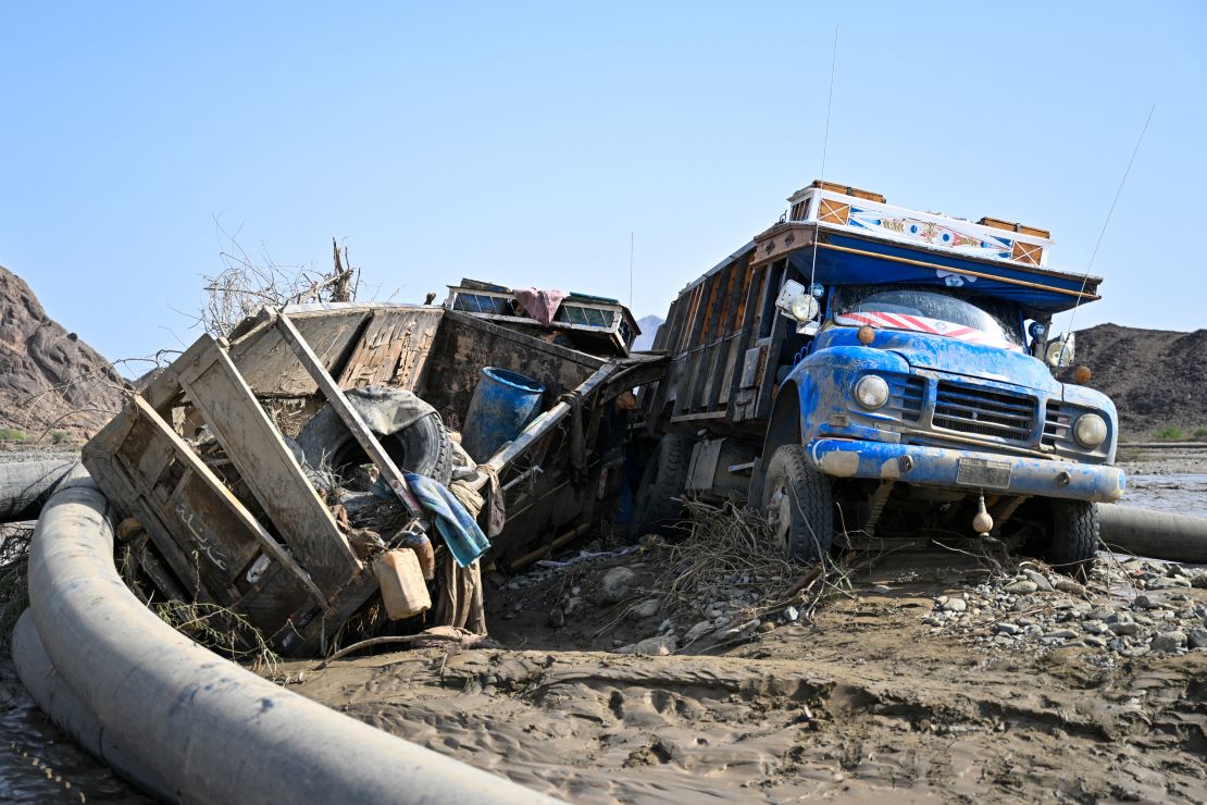 Damaged trucks buried in the mud after the collapse of the Arba'at Dam in Sudan following heavy rains and torrential floods on August 25, 2024.