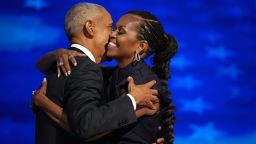 Former U.S. President Barack Obama (L) greets former first lady Michelle Obama as he arrives to speak on stage during the second day of the Democratic National Convention at the United Center on August 20, 2024 in Chicago, Illinois. Delegates, politicians, and Democratic Party supporters are gathering in Chicago, as current Vice President Kamala Harris is named her party's presidential nominee. The DNC takes place from August 19-22.