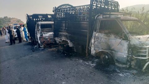 Security personnel stand near the charred vehicles at the shooting site on the national highway in Musakhail district, Balochistan province on August 26, 2024. Separatist gunmen shot and killed at least 22 people in southwest Pakistan on August 26 in an attack that singled out ethnic Punjabis, government officials said. Dozens of militants carried out the shootings early Monday in the district of Musakhail in impoverished Balochistan province, where security forces are battling sectarian, ethnic and separatist violence. (Photo by AFP) (Photo by STR/AFP via Getty Images)