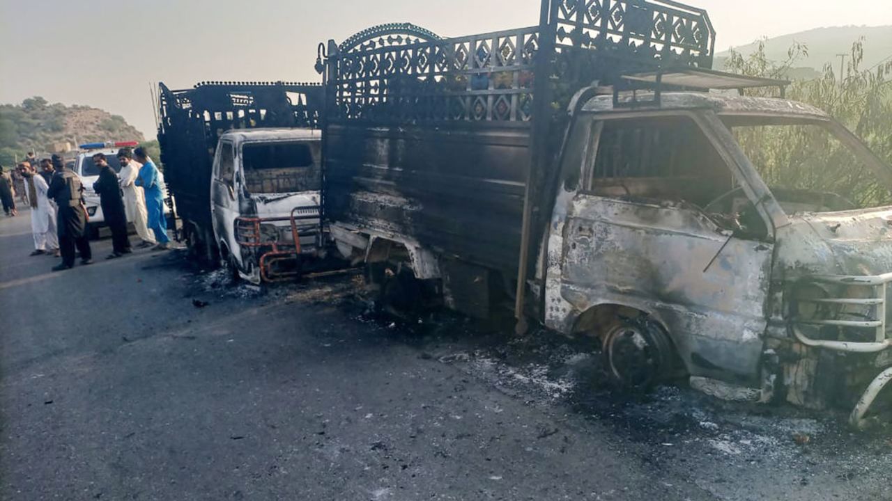 Security personnel stand near the charred vehicles at the shooting site on the national highway in Musakhail district, Balochistan province on August 26, 2024. Separatist gunmen shot and killed at least 22 people in southwest Pakistan on August 26 in an attack that singled out ethnic Punjabis, government officials said. Dozens of militants carried out the shootings early Monday in the district of Musakhail in impoverished Balochistan province, where security forces are battling sectarian, ethnic and separatist violence. (Photo by AFP) (Photo by STR/AFP via Getty Images)