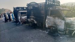 Security personnel stand near the charred vehicles at the shooting site on the national highway in Musakhail district, Balochistan province on August 26, 2024. Separatist gunmen shot and killed at least 22 people in southwest Pakistan on August 26 in an attack that singled out ethnic Punjabis, government officials said. Dozens of militants carried out the shootings early Monday in the district of Musakhail in impoverished Balochistan province, where security forces are battling sectarian, ethnic and separatist violence. (Photo by AFP) (Photo by STR/AFP via Getty Images)