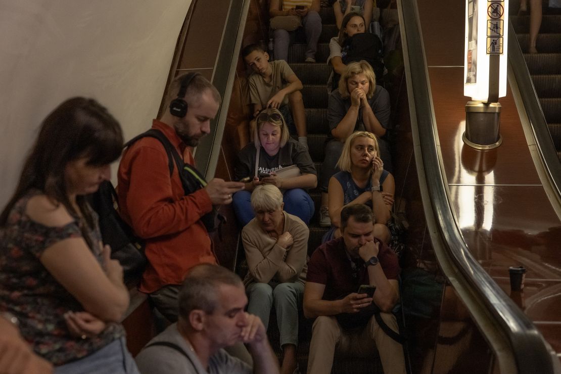 TOPSHOT - People take shelter in the Teatralna metro station during a Russian air attack, in Kyiv, on August 26, 2024, amid the Russian invasion of Ukraine. Russian drones and missiles on August 26, 2024, targeted 15 regions across Ukraine in an overnight barrage aimed mainly at energy infrastructure, Ukrainian Prime Minister Denys Shmygal said. (Photo by Roman PILIPEY / AFP) (Photo by ROMAN PILIPEY/AFP via Getty Images)