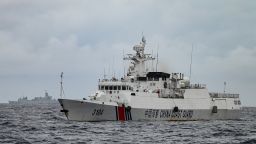 A China Coast Guard ship (R) and a vessel identified by the Philippine Coast Guard as a Chinese navy ship (background L) are seen from the Philippine Coast Guard vessel BRP Cabra during a supply mission to Sabina Shoal in disputed waters of the South China Sea on August 26, 2024.